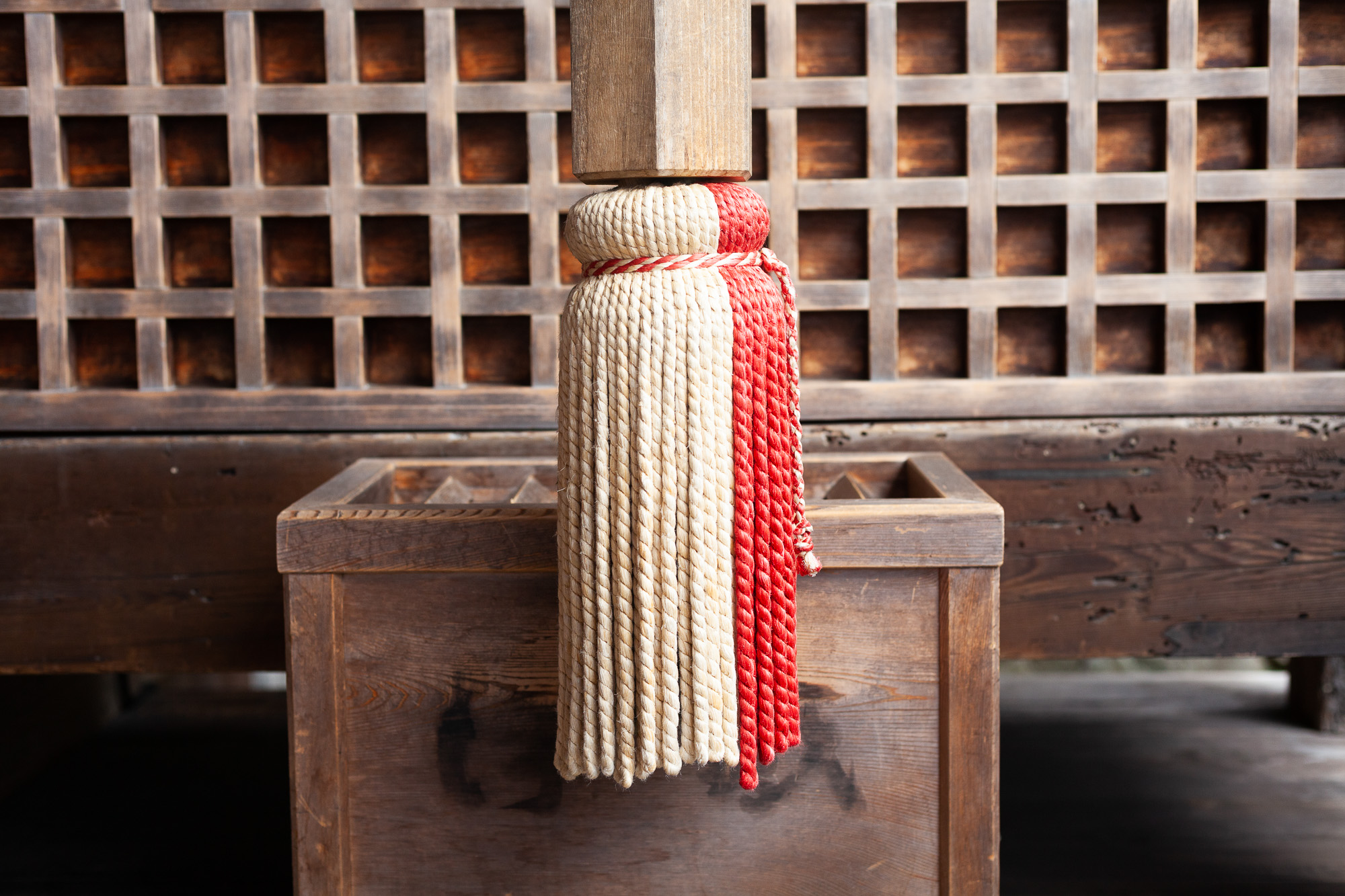 A red and white hanging thing at a shrine.